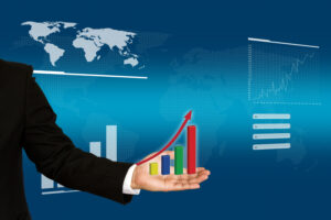 Businessperson holding a rising bar chart with upward arrow, symbolising tiffin services market growth, with a world map and data graphics in the background.